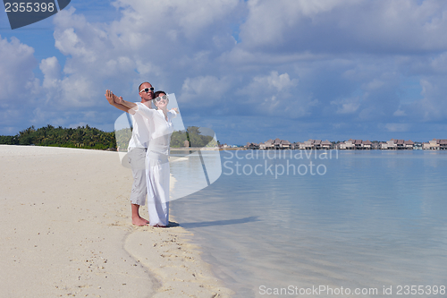 Image of happy young  couple at summer vacation have fun and relax at bea