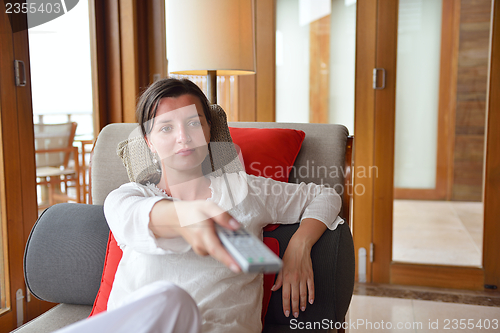 Image of happy young woman relax at home on sofa