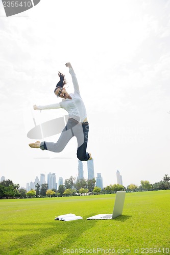 Image of woman with laptop in park