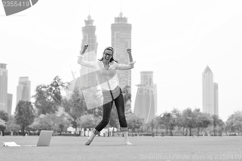 Image of woman with laptop in park