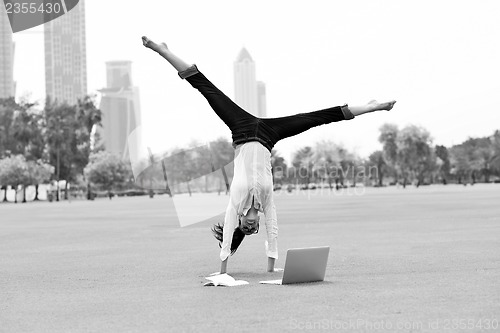 Image of woman with laptop in park