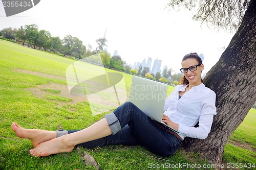 Image of woman with laptop in park