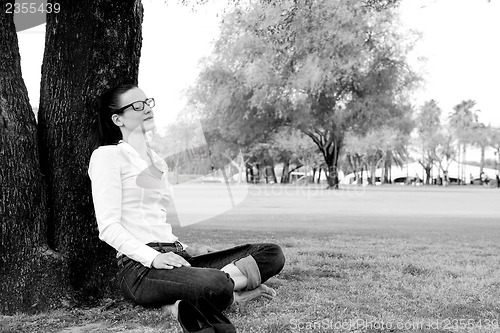 Image of Beautiful young woman with  tablet in park