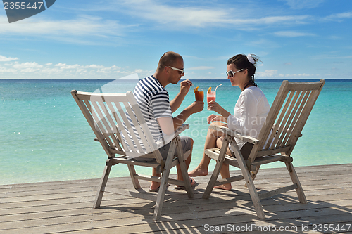 Image of happy young couple relax and take fresh drink