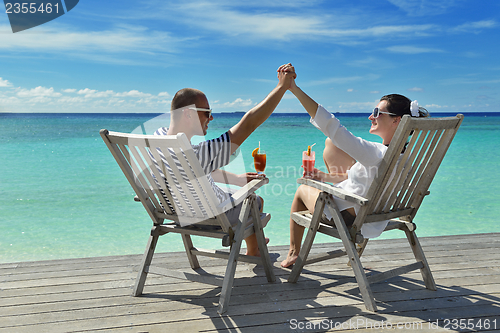 Image of happy young couple relax and take fresh drink