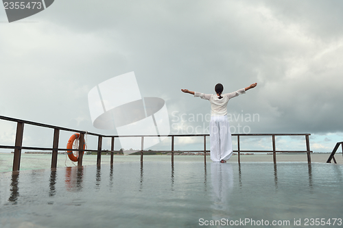 Image of young woman relax on cloudy summer day