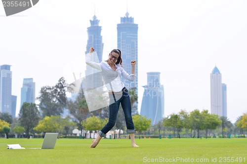 Image of woman with laptop in park