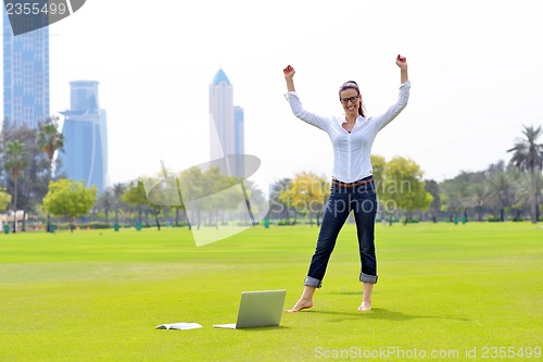 Image of woman with laptop in park