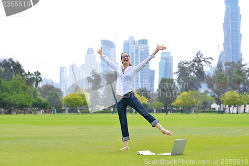 Image of woman with laptop in park