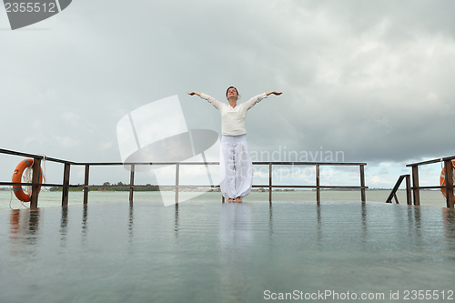 Image of young woman relax on cloudy summer day