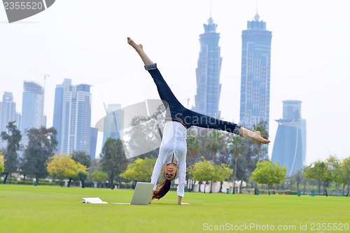 Image of woman with laptop in park