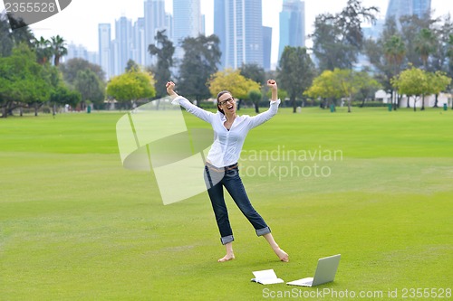 Image of woman with laptop in park