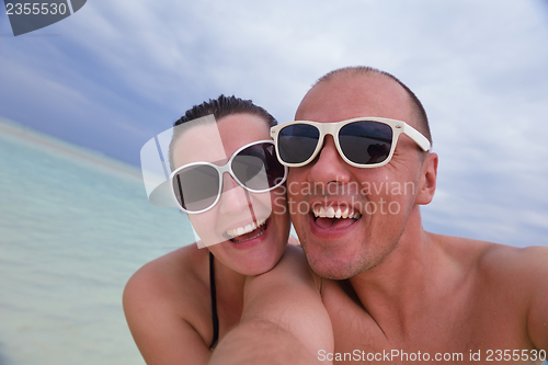 Image of happy young  couple at summer vacation have fun and relax at bea