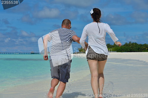Image of happy young  couple at summer vacation have fun and relax at bea