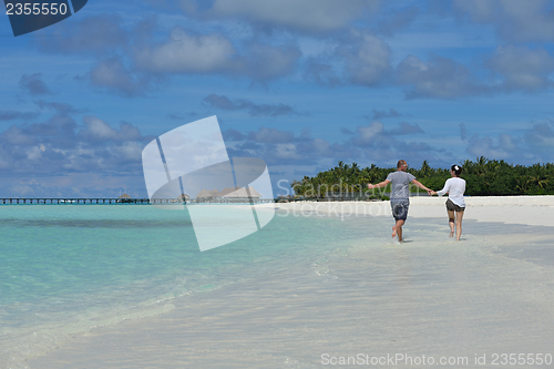 Image of happy young  couple at summer vacation have fun and relax at bea