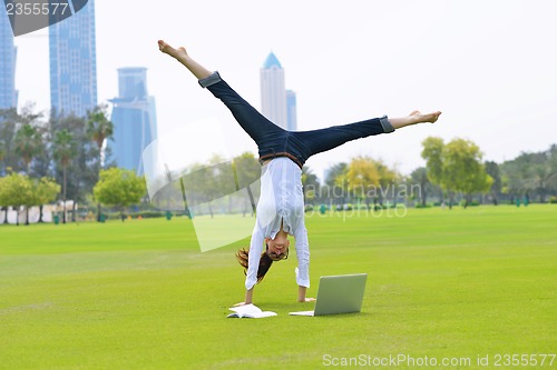 Image of woman with laptop in park