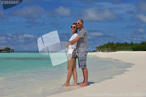 Image of happy young  couple at summer vacation have fun and relax at bea