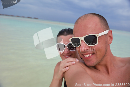 Image of happy young  couple at summer vacation have fun and relax at bea