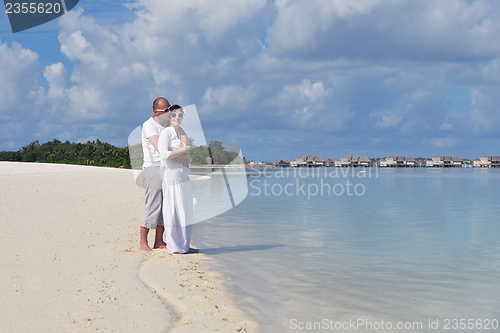 Image of happy young  couple at summer vacation have fun and relax at bea