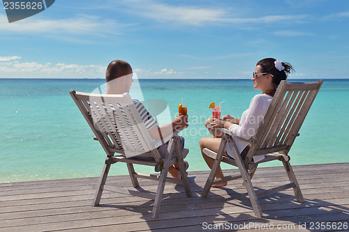 Image of happy young couple relax and take fresh drink