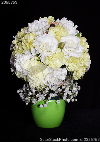 Image of round festive bouquet of yellow carnations