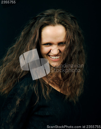 Image of beautiful girl with long hair grins