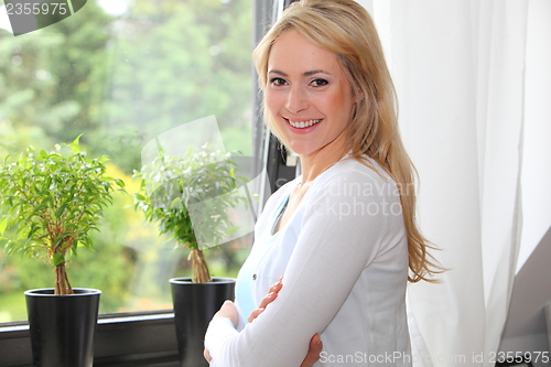 Image of Beautiful woman in front of a view window