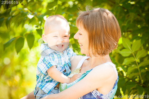Image of Mom and son playing outdoor together