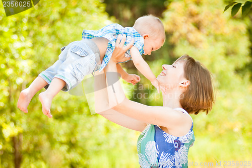 Image of Mom and son playing outdoor together