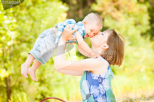 Image of Mom and son playing outdoor together