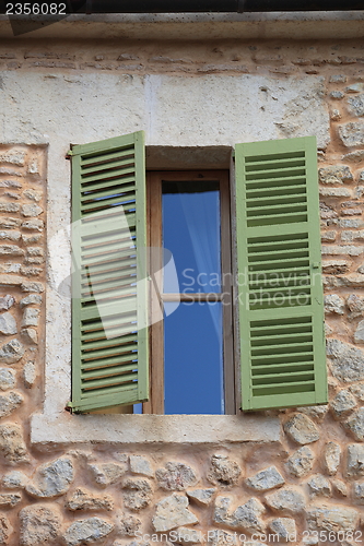 Image of Window with green wooden shutters