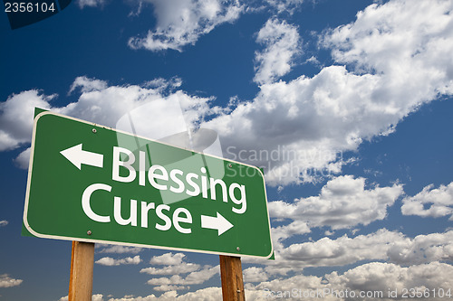 Image of Blessing, Curse Green Road Sign and Clouds