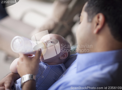 Image of Happy Hispanic Father Bottle Feeding His Mixed Race Son