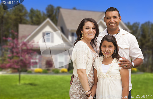 Image of Small Hispanic Family in Front of Their Home