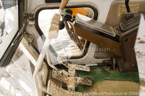 Image of inside tractor cabin device gears handles pedals 