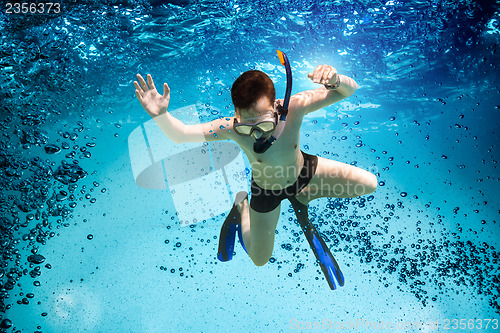 Image of Teenager in the mask and snorkel swim underwater.