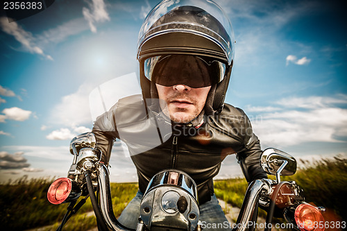 Image of Biker racing on the road