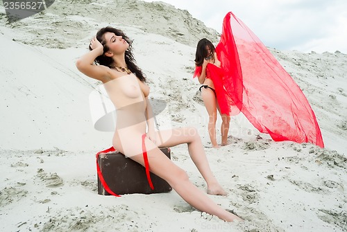 Image of Attractive naked girls on sand
