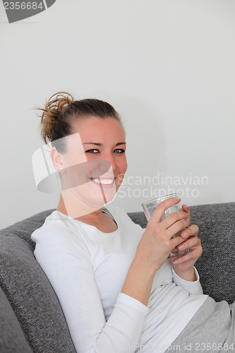 Image of Smiling woman enjoying a cappuccino