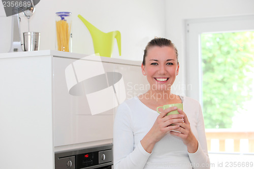 Image of Happy housewife enjoying coffee