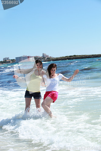 Image of Two women frolicking in the sea