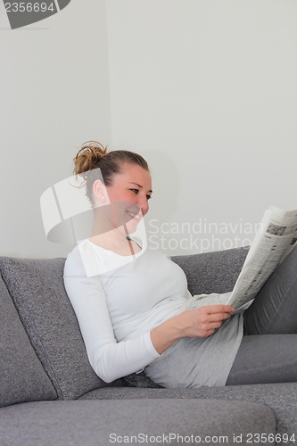 Image of Woman enjoying her morning newspaper