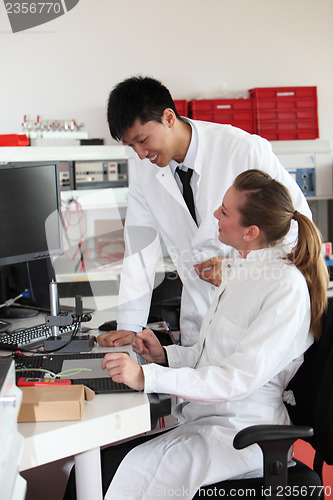 Image of Two lab technicians discussing their work