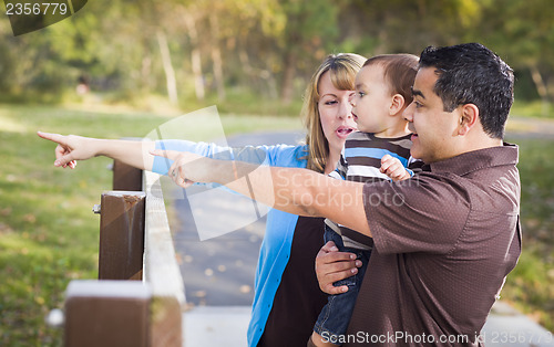 Image of Happy Mixed Race Family Playing In The Park