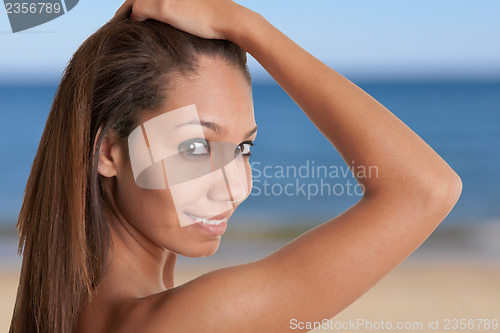 Image of Beautiful African Woman Holding Her Hair and Smiling