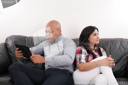 Image of A couple having argument while sitting on the sofa