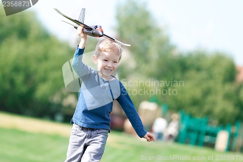Image of boy playing his toy plane