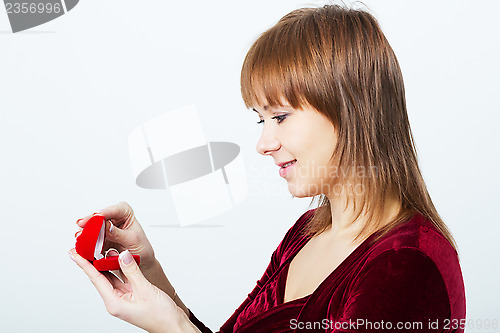 Image of young attractive woman with a box for rings