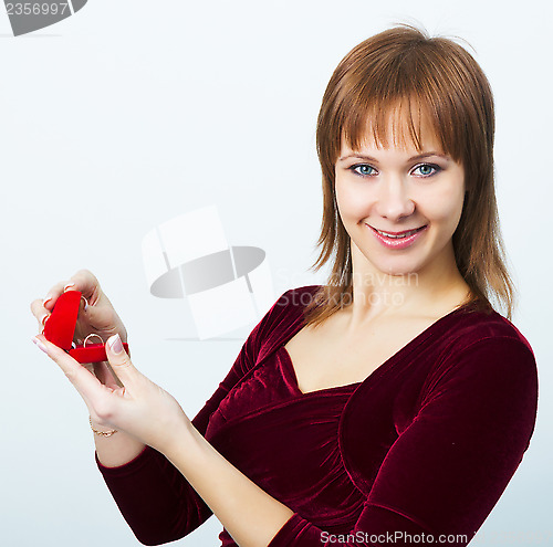 Image of young attractive woman with a box for rings