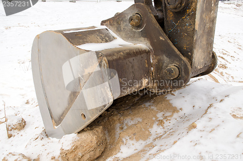 Image of excavator bucket close sand pit quarry snow winter 